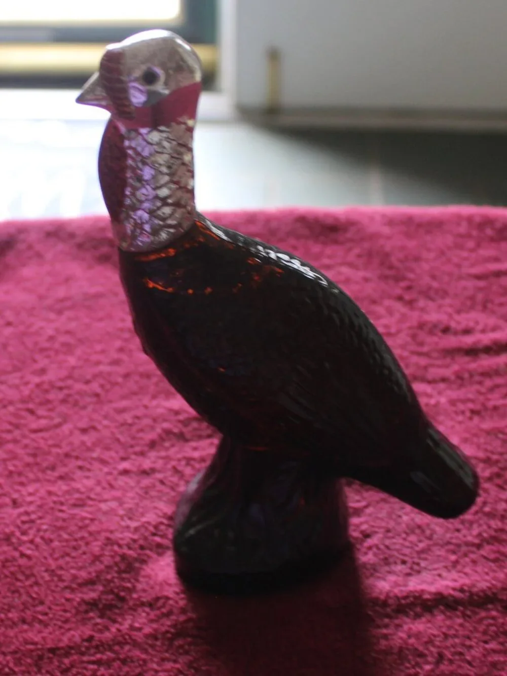 Vintage Avon Wild Turkey bottle, featuring brown glass and a silver-colored head